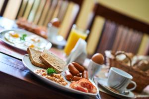 a table with two plates of breakfast foods and eggs at Hotel Stará Pekárna s privátním wellness in Liberec