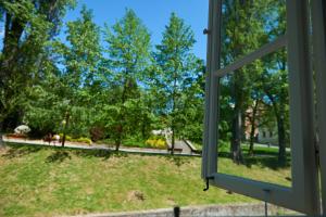 a window looking out at a park with trees at Hotel Stará Pekárna s privátním wellness in Liberec +15 photos