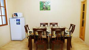 a dining room table with chairs and a refrigerator at Nautilus in Odesa