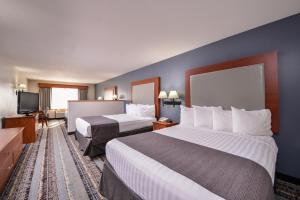 a hotel room with two beds and a flat screen tv at Best Western Newberg Inn in Newberg +88 photos