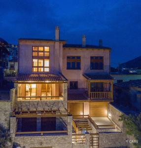 a large house with lights on top of it at Kallisto Mountain House I in Arachova