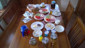 a wooden table with plates of food on it at Rodinný Penzion u Wolfů in Chrastava