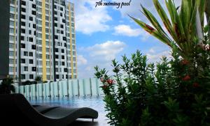 a swimming pool with two tall buildings and some plants at H2H - Euro House @ Majestic Ipoh (8~10 Guests) in Ipoh