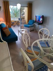 a living room with a couch and chairs and a tv at Venturamar in Gran Tarajal