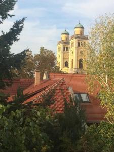 a building with a clock tower on top of a roof at Nimród Apartman in Eger