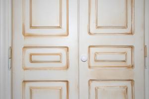 a white door with two glass panels on it at Paris Studios & Apartment in Agia Paraskevi
