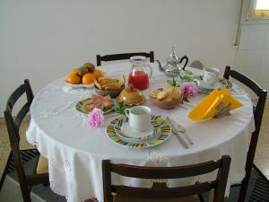 a table with a white table cloth with food on it at B&B Carlotta in Bologna