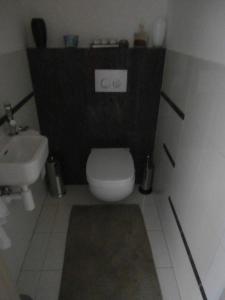 a bathroom with a white toilet and a sink at Apartmán Deluxe in Banská Bystrica