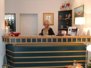 a woman sitting at a bar in a room at Hotel Garni Classico in Aschaffenburg