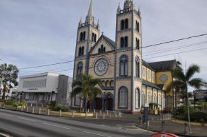 a church with two towers on the side of a street at Riando appartement Rainville in Paramaribo