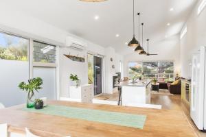 a kitchen and living room with white walls and a table at Sea View at Silver Sands - C21 SouthCoast Holidays in Aldinga Beach