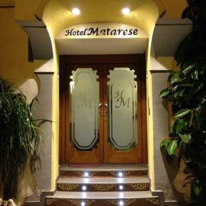 a pair of wooden doors in a building at Hotel & Residence Matarese in Ischia