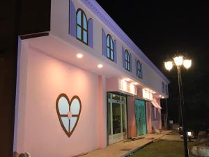 a building with a heart painted on the side of it at Jing Lai Hui Lan Homestay in Ruisui