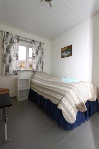 A bed or beds in a room at Guesthouse Steindórsstadir, West Iceland