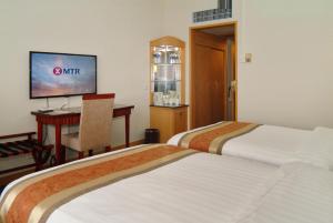 Postel nebo postele na pokoji v ubytování Guangdong Hotel-Free Shuttle & Registration Counter Service during Canton Fair