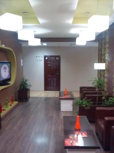 a lobby with a waiting room with a tv at Garni Hotel Tri O in Kragujevac