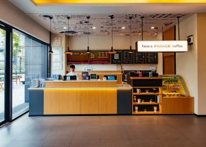 a person sitting at a counter in a fast food restaurant at Hanting Hotel Hangzhou Xiasha Shang Mao Cheng Branch in Hangzhou