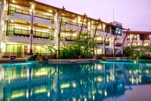 a building with a swimming pool in front of it at The Elements Krabi Resort - SHA Plus in Klong Muang Beach