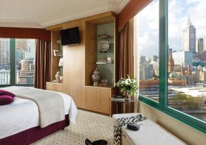 
a hotel room with a view of the city at The Langham Melbourne in Melbourne
