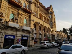 a group of cars parked in front of a building at Apartment Abdulkerim Ali-Zadeh 6 in Baku