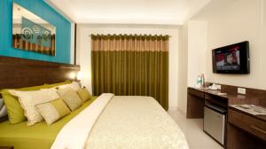 Ein Bett oder Betten in einem Zimmer der Unterkunft BIZZ Tamanna Hotel
