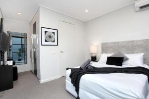 A bed or beds in a room at StayCentral - Little Collins CBD