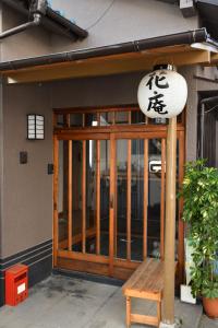 a door to a restaurant with a bench in front of it at Hostel Hana An in Tokyo