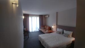 Postel nebo postele na pokoji v ubytování Family Hotel Muses