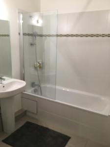 a bathroom with a shower and a tub and a sink at Sleep in Paris Val d'Europe in Chessy +29 photos
