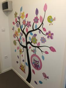 a tree with flowers and birds on a wall at Sleep in Paris Val d'Europe in Chessy