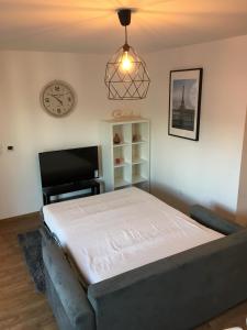 a bedroom with a bed and a clock on the wall at Sleep in Paris Val d'Europe in Chessy +29 photos