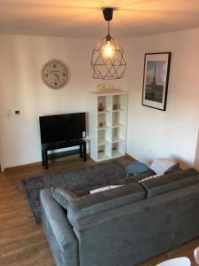 a living room with a couch and a piano at Sleep in Paris Val d'Europe in Chessy