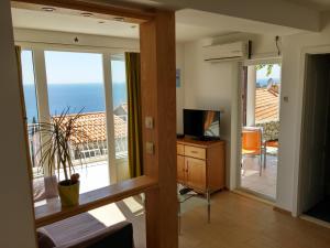 a living room with a view of the ocean at Apartments Novak in Dubrovnik