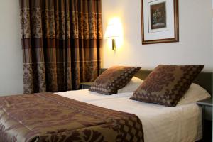 Postel nebo postele na pokoji v ubytování Hotel Iris