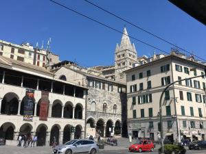 a city street with cars parked in front of buildings at Casa Costa Classica in Genova