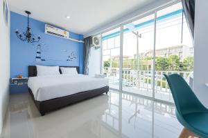 a bedroom with a bed and a balcony at Slowlife Beach in Nai Yang Beach