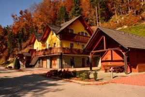 a large house with a balcony on a mountain at Apartments Gatej in Cerkno