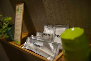 a shelf with packages of toiletries on it at Grandmas Plus Hotel Seminyak in Seminyak