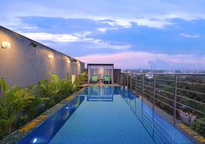 a swimming pool on the roof of a building at Fortune Park Sishmo, Bhubaneshwar - Member ITC's Hotel Group in Bhubaneshwar