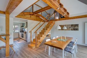 a dining room with a wooden table and stairs at Spreewaldferienhaus - Urlaub in Lübben
