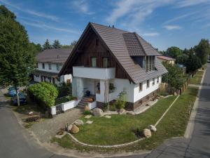 a white house with a brown roof at Spreewaldferienhaus - Urlaub in Lübben
