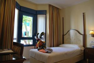 a hotel room with a bed and a window at Hotel Golf Campoamor in Dehesa de Campoamor +50 photos