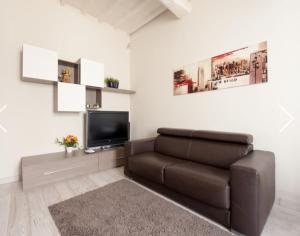 a living room with a couch and a flat screen tv at Modern Apartment Sant'Antonino in Florence