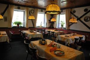 a dining room with tables and chairs and lights at Dinkelsbühler Hof in Dinkelsbühl