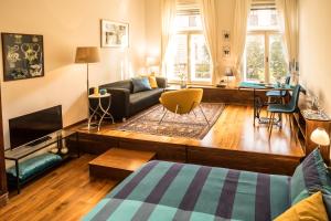 a living room with a couch and a table at Parliament Suite with a view in Budapest