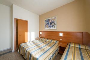 Postel nebo postele na pokoji v ubytování Hotel Moderno