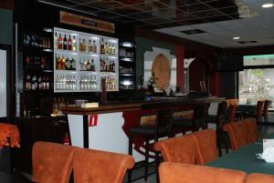 a bar in a restaurant with orange chairs at Rogatka in Rogówko