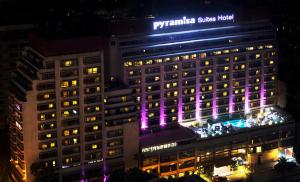a building with purple lights on it at night at Pyramisa Suites Hotel Cairo in Cairo