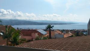 una vista del agua desde el techo de una casa en Villa Grande, en Messina