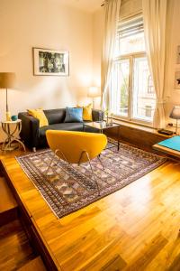 a living room with a couch and a table at Parliament Suite with a view in Budapest